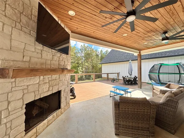 a living room with furniture a fireplace and a table