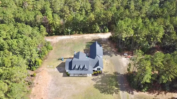 a view of a chairs and table in the backyard