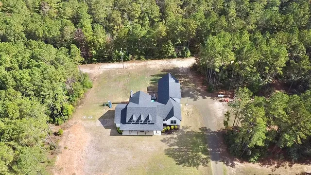 a view of a chairs and table in the backyard