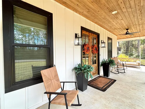 a dining room with furniture and a potted plant