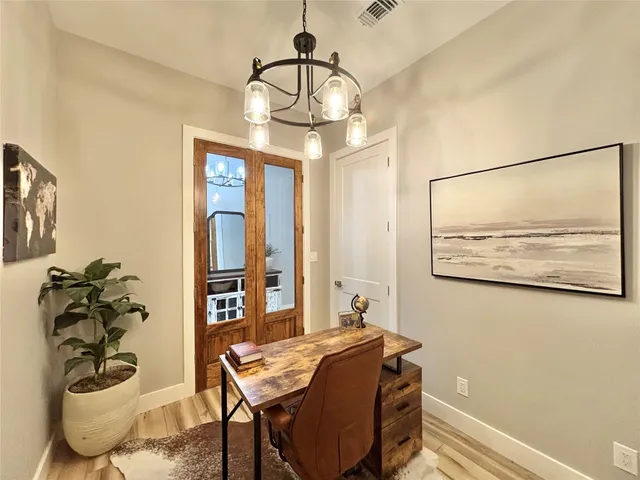 a view of a dining room with furniture and chandelier