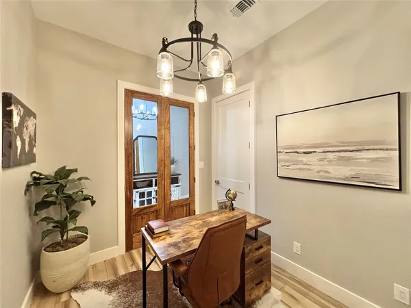 a view of a dining room with furniture and chandelier