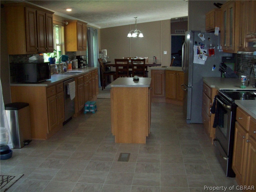 133 Dixon Road Hudgins, VA 23076 - Photo 8 of 25 a kitchen with a refrigerator and a stove