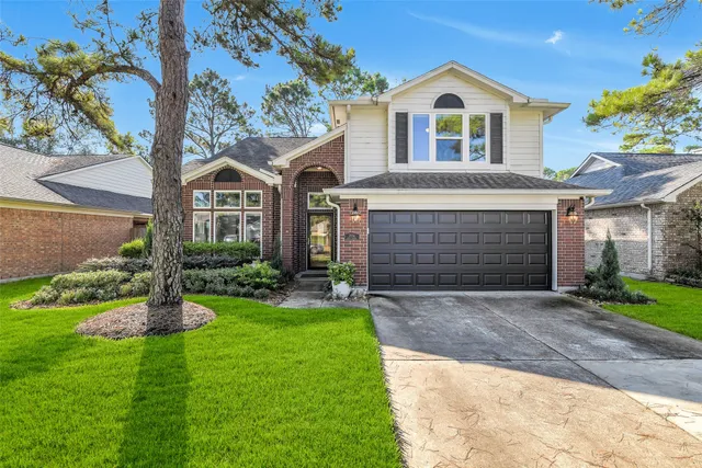 a front view of a house with a yard and garage