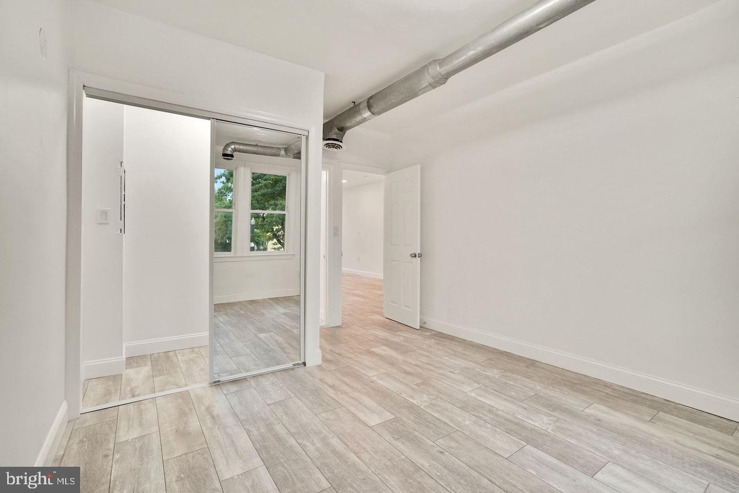 5413 Georgia Avenue Northwest Washington, DC 20011 - Photo 11 of 22 wooden floor in an empty room