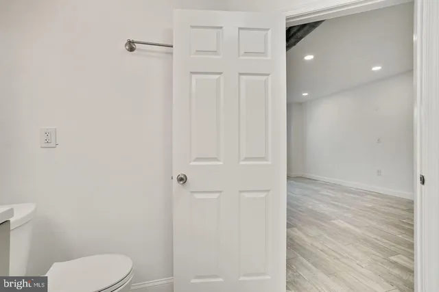 a bathroom with a toilet and a shower