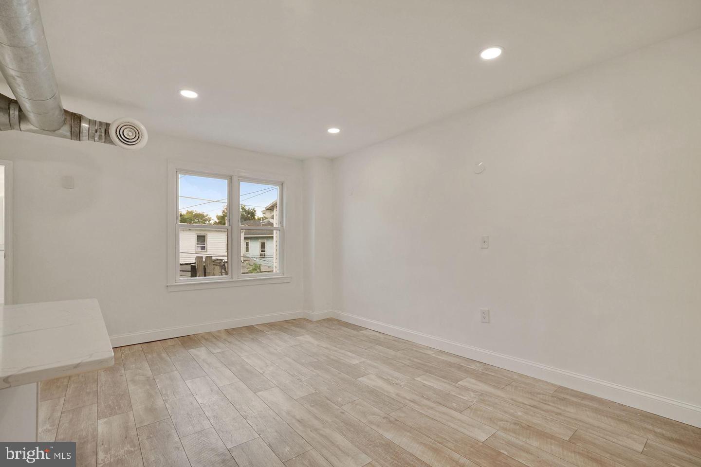 5413 Georgia Avenue Northwest Washington, DC 20011 - Photo 18 of 22 an empty room with wooden floor and windows