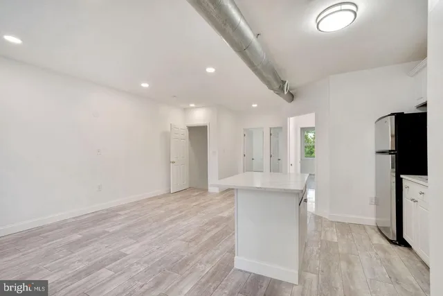 a view of kitchen with furniture and refrigerator
