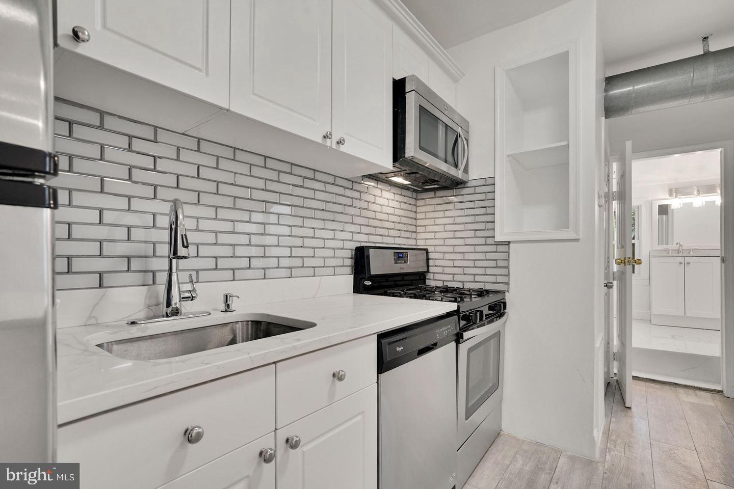 5413 Georgia Avenue Northwest Washington, DC 20011 - Photo 21 of 22 a kitchen with stainless steel appliances a sink dishwasher a refrigerator and cabinets