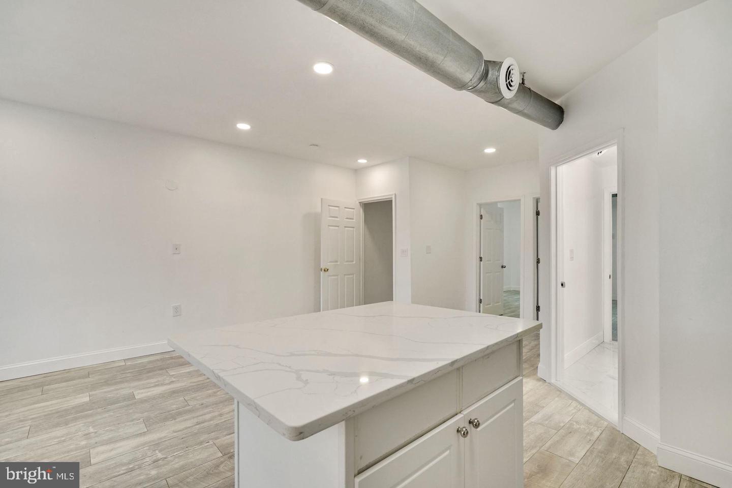 5413 Georgia Avenue Northwest Washington, DC 20011 - Photo 4 of 22 a bathroom with a granite countertop sink and a mirror