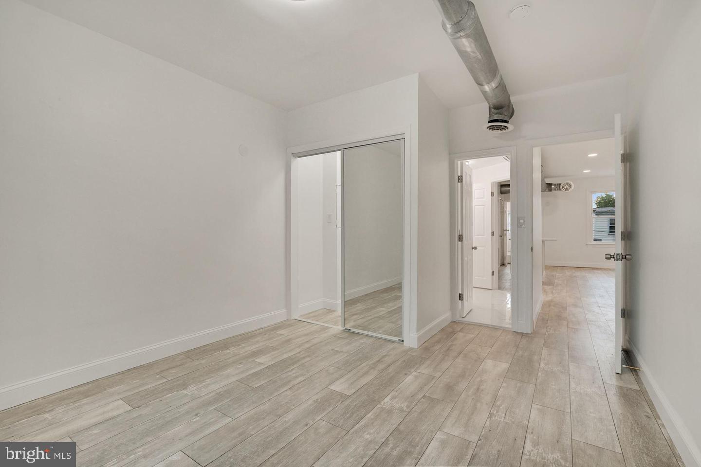 5413 Georgia Avenue Northwest Washington, DC 20011 - Photo 7 of 22 wooden floor in an empty room
