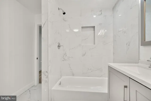 a bathroom with a bathtub and a sink