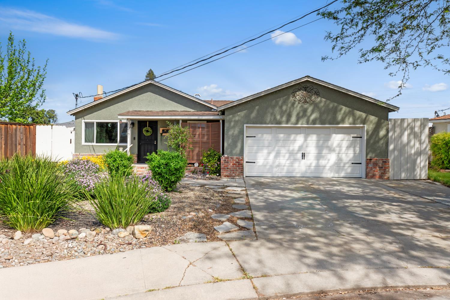 1217 Karen Way Modesto, CA 95350 - Photo 1 of 1 a front view of a house with garden