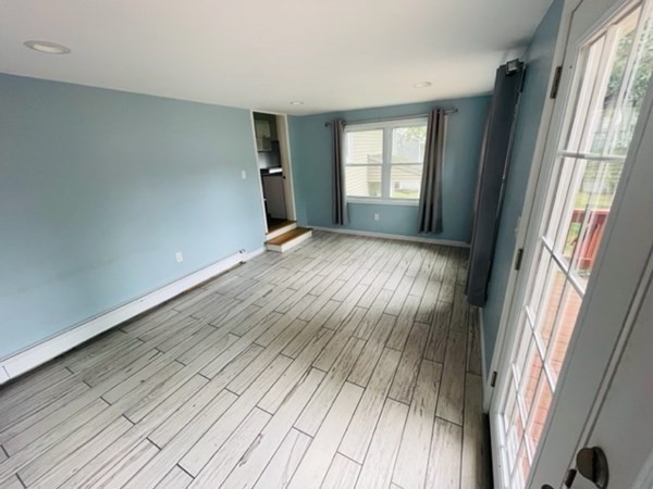 102 Harrow Road Springfield, MA 01118 - Photo 13 of 35 an empty room with wooden floor and windows