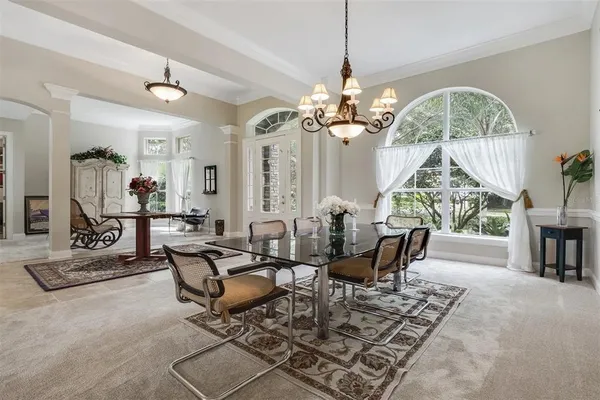 a living room with furniture a chandelier and a chandelier