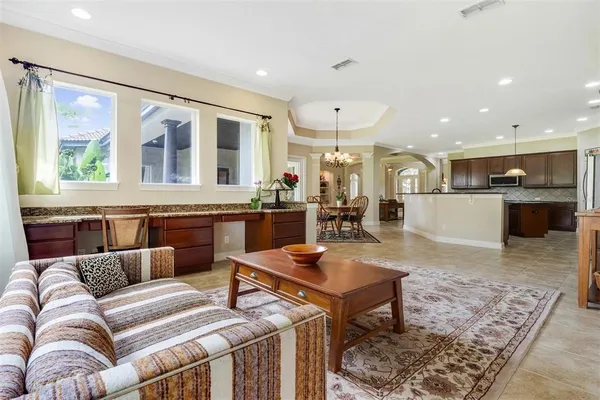 a living room with furniture a window and a chandelier