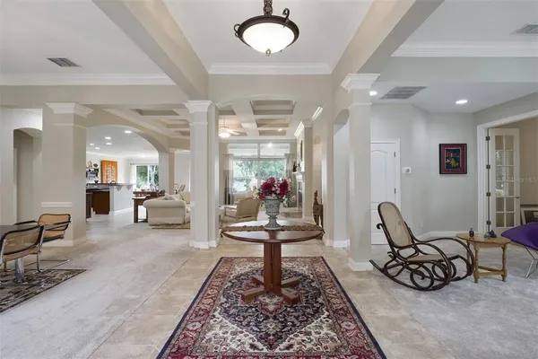 a living room with furniture rug and a chandelier