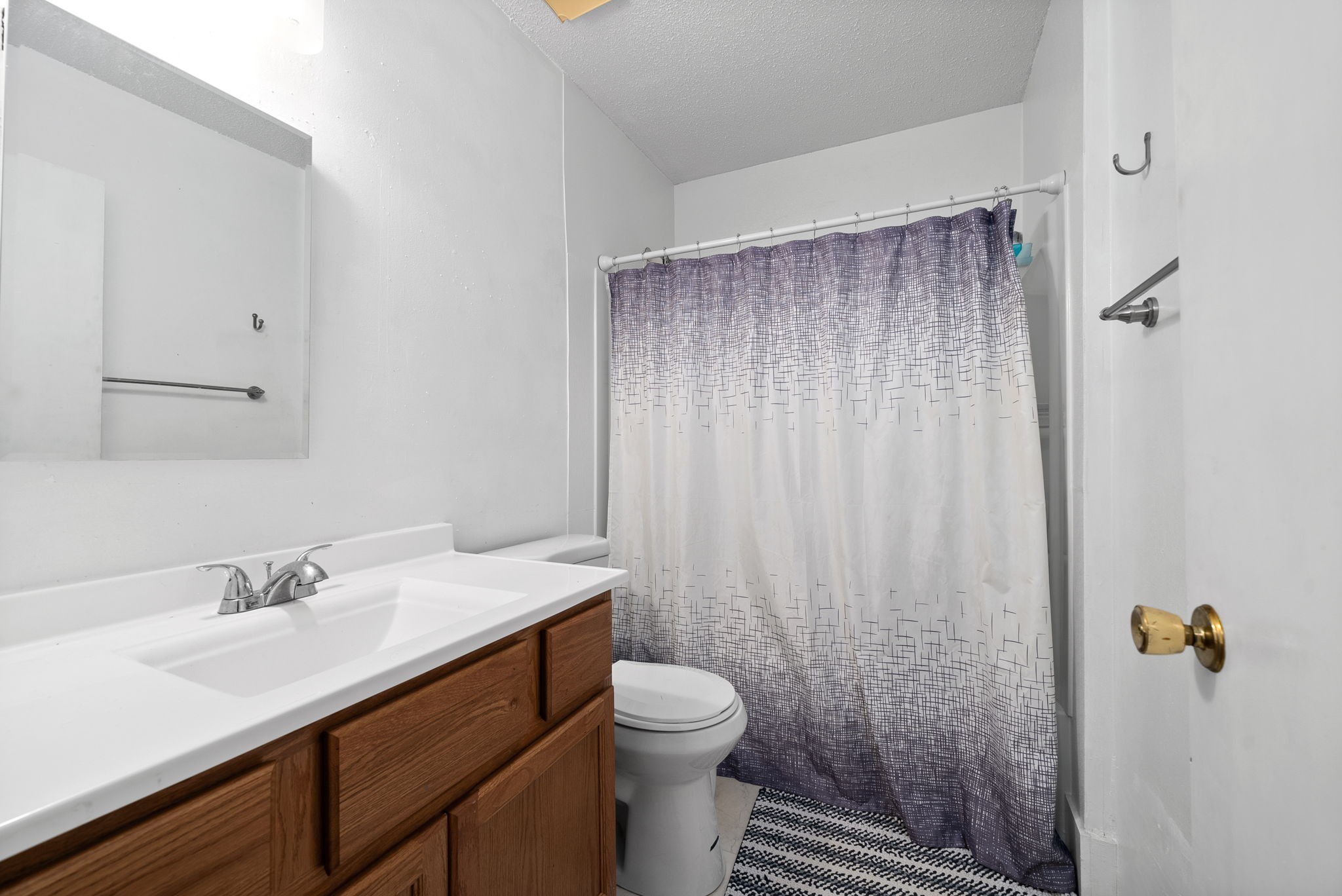 1044 Pembroke Oak Grove Road Oak Grove, KY 42262 - Photo 27 of 40 a bathroom with a sink a toilet a mirror and shower curtain
