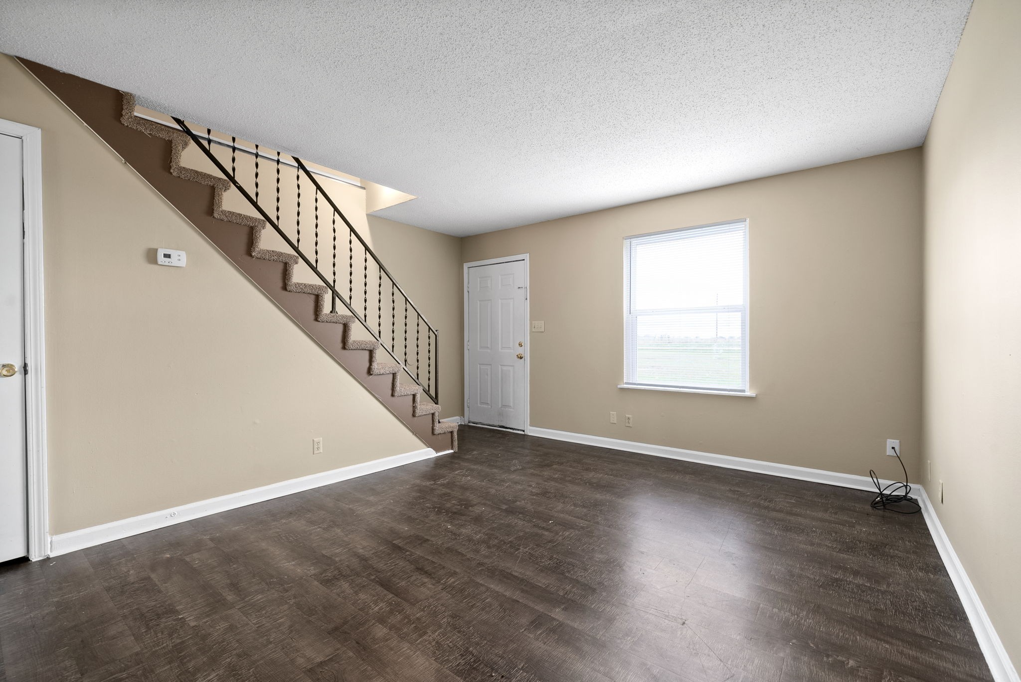 1044 Pembroke Oak Grove Road Oak Grove, KY 42262 - Photo 8 of 40 a view of an empty room with wooden floor and stairs