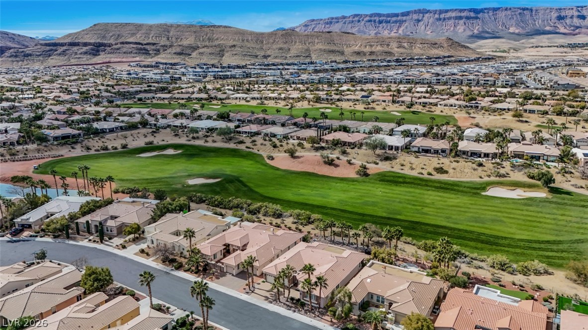 5015 Rivedro Street Las Vegas, NV 89135 - Photo 72 of 91 An aerial perspective reveals a vibrant golf course community nestled against a striking mountain backdrop.