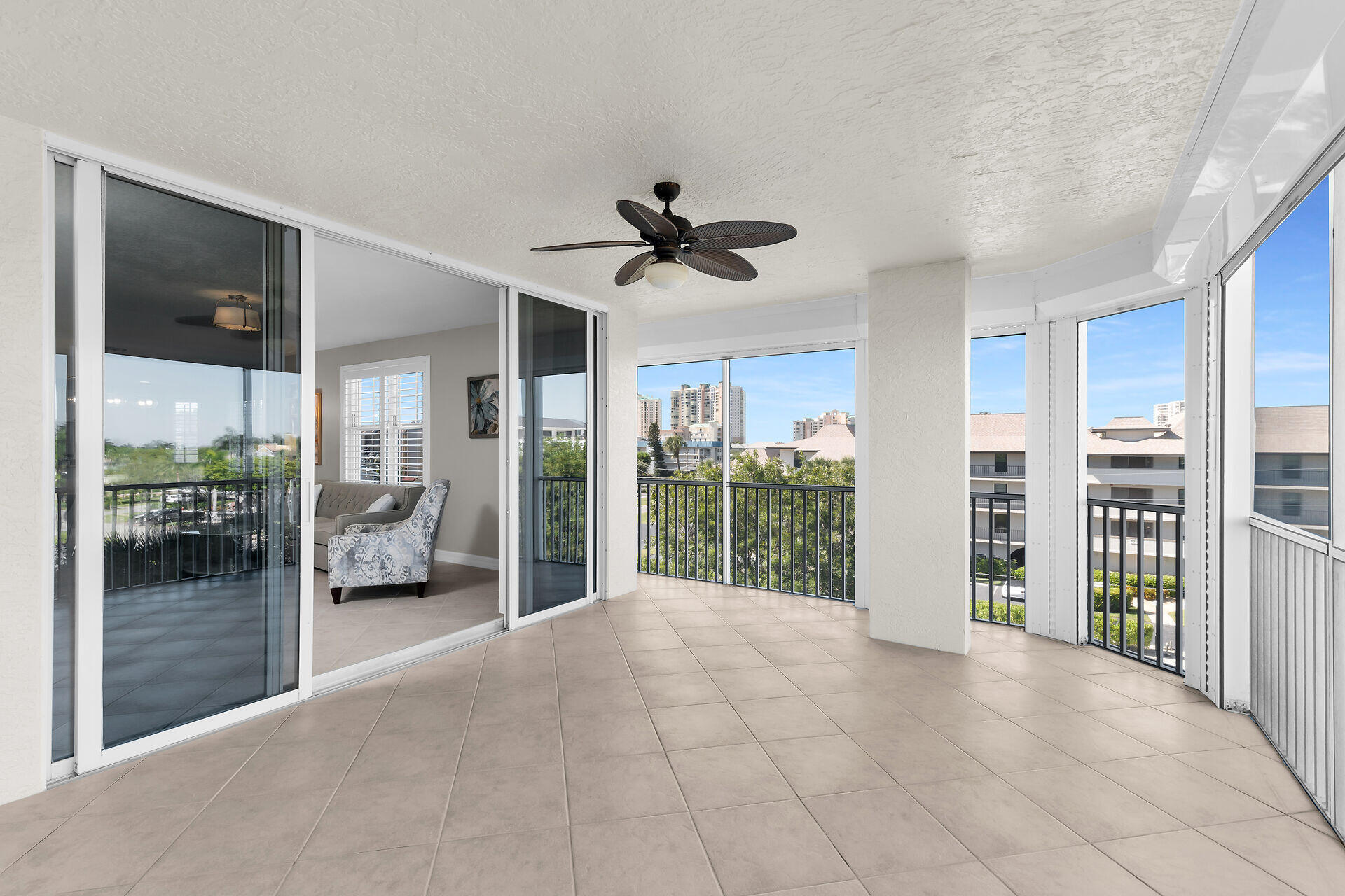 1111 Swallow Avenue, Unit 1401 Marco Island, FL 34145 - Photo 29 of 36 a view of a livingroom with a chandelier fan and windows