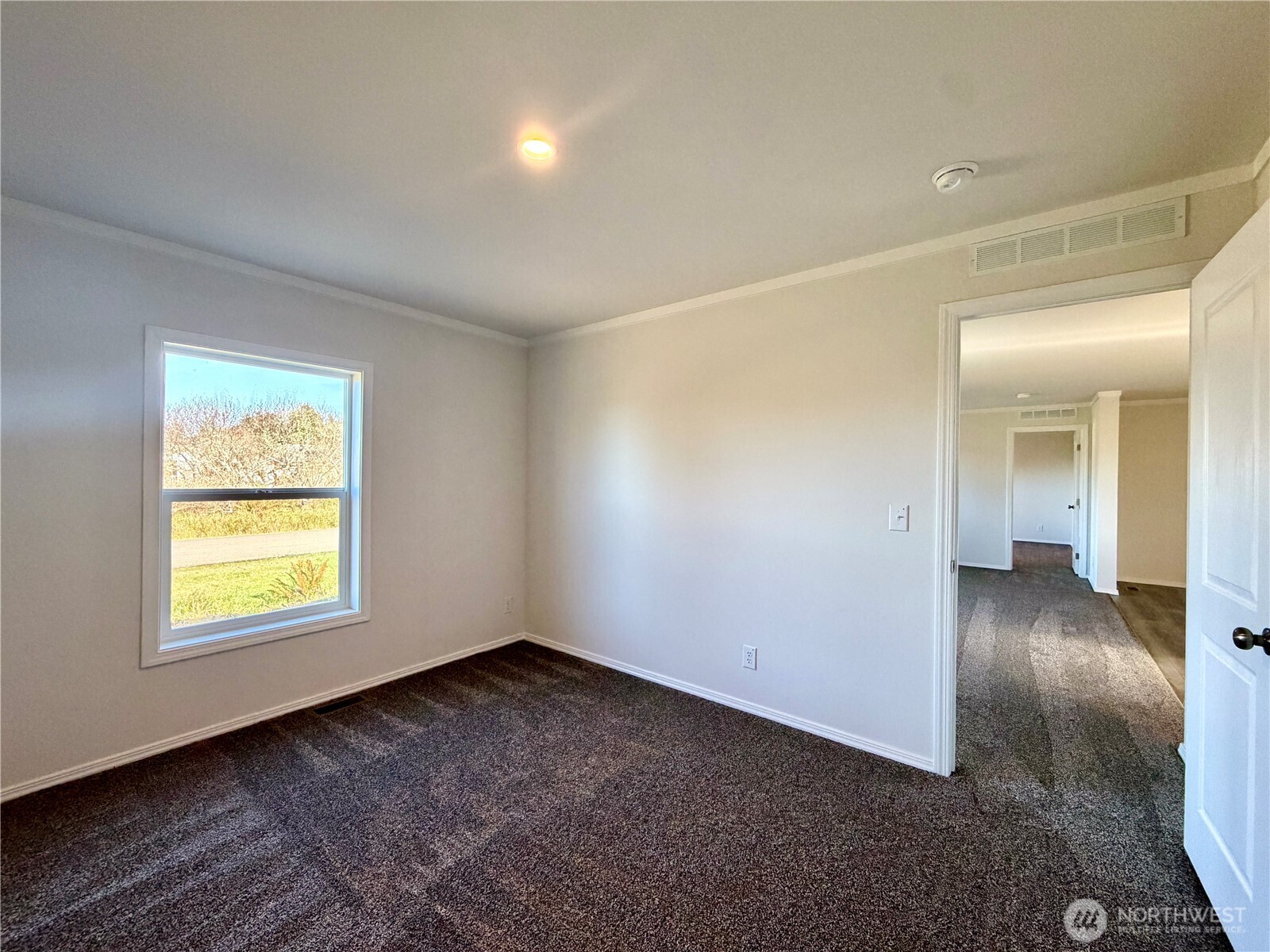 299 Octopus Avenue Northeast Ocean Shores, WA 98569 - Photo 23 of 40 an empty room with a window and wooden floor