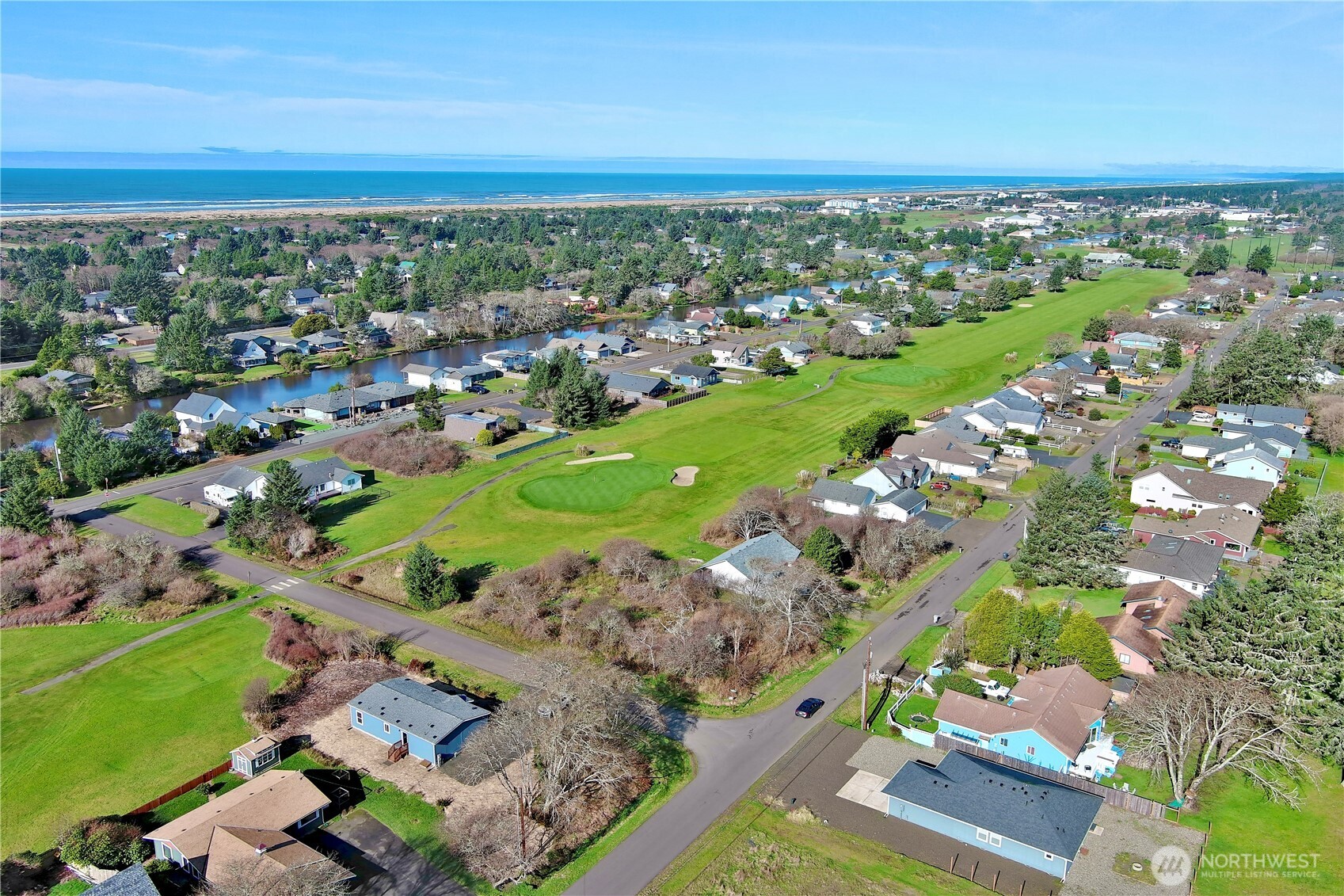 299 Octopus Avenue Northeast Ocean Shores, WA 98569 - Photo 36 of 40 an aerial view of a city with lots of residential buildings ocean and mountain view in back