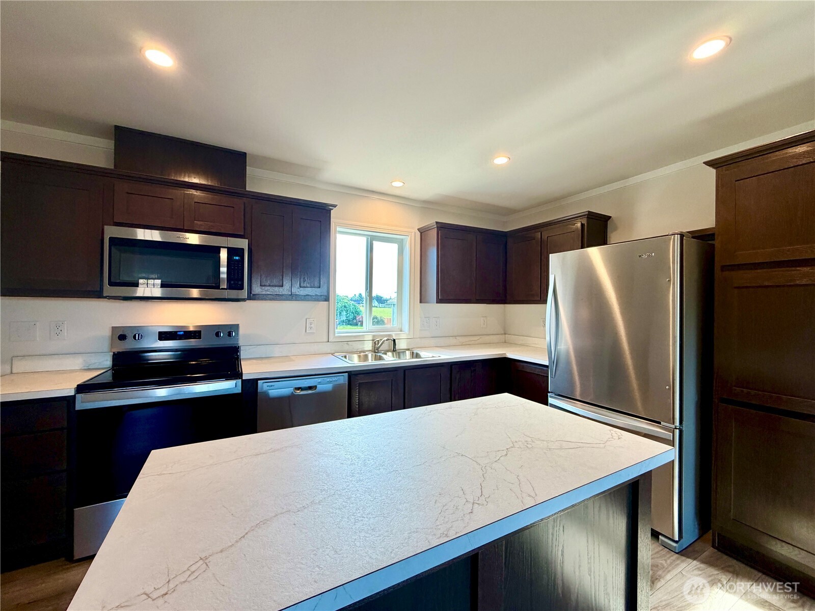 299 Octopus Avenue Northeast Ocean Shores, WA 98569 - Photo 7 of 40 a kitchen with stainless steel appliances a refrigerator and a stove top oven