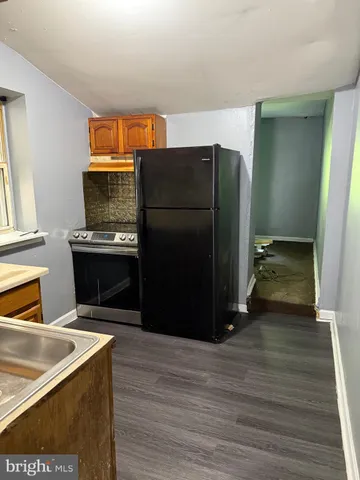 a kitchen with stainless steel appliances granite countertop a sink and a stove
