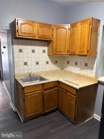a kitchen with a refrigerator and a stove