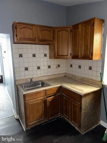 a kitchen with a refrigerator and a stove