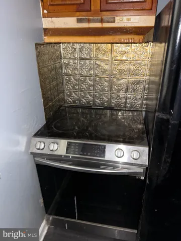 a kitchen with granite countertop cabinets and wooden floor