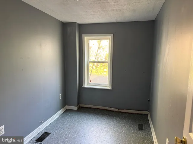 a view of an empty room with closet area