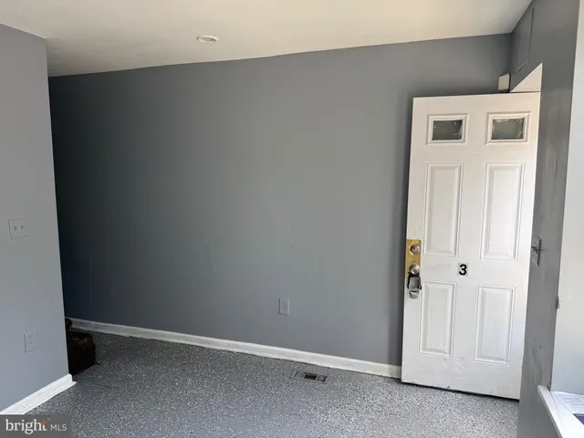 an empty room with wooden floor