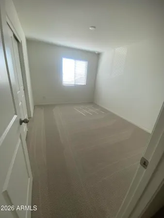 a view of an empty room and a window