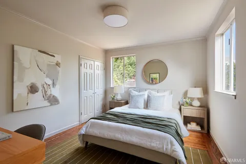 a bedroom with a bed and a painting on the wall