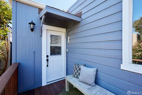 a view of wooden door and chair in the room