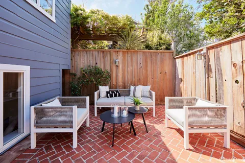 a outdoor space with a couch and chairs