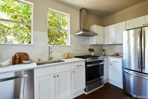 a kitchen with stainless steel appliances a stove a sink and a refrigerator