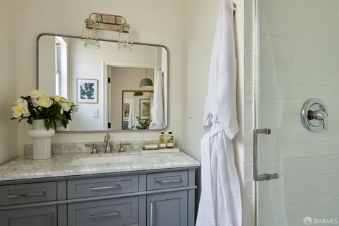 a bathroom with a granite countertop sink vanity and a mirror