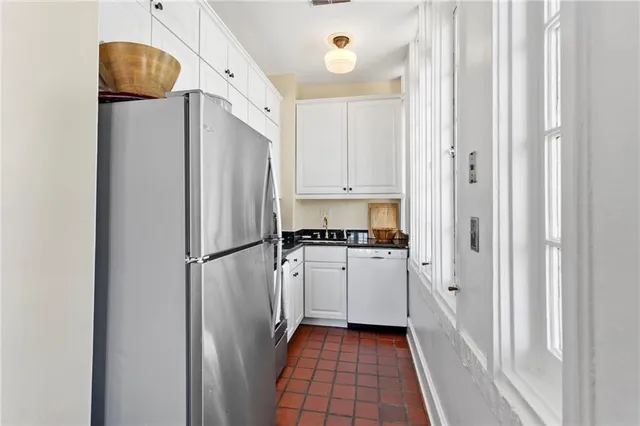 a kitchen with stainless steel appliances a refrigerator and a stove