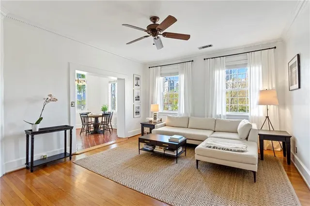 a living room with furniture and wooden floor