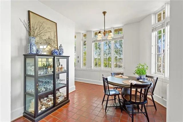 a view of a dining room with furniture large windows and wooden floor