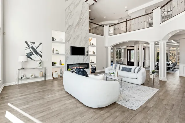 a living room with furniture a fireplace and a flat screen tv