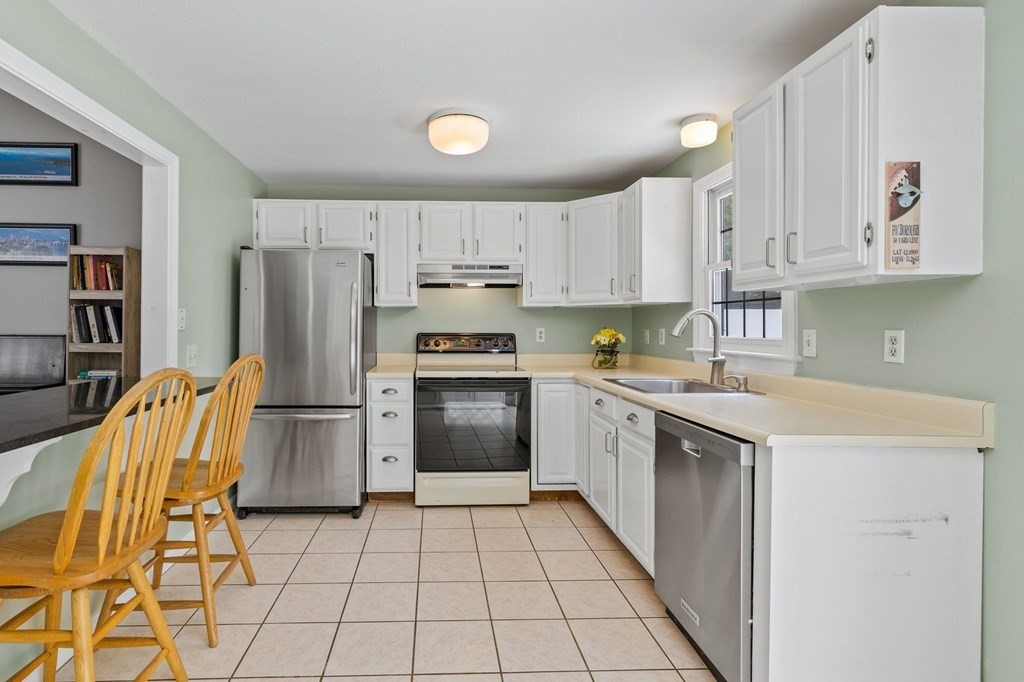 225 Skunknet Road Barnstable, MA 02632 - Photo 11 of 27 a kitchen with a sink a refrigerator and a stove