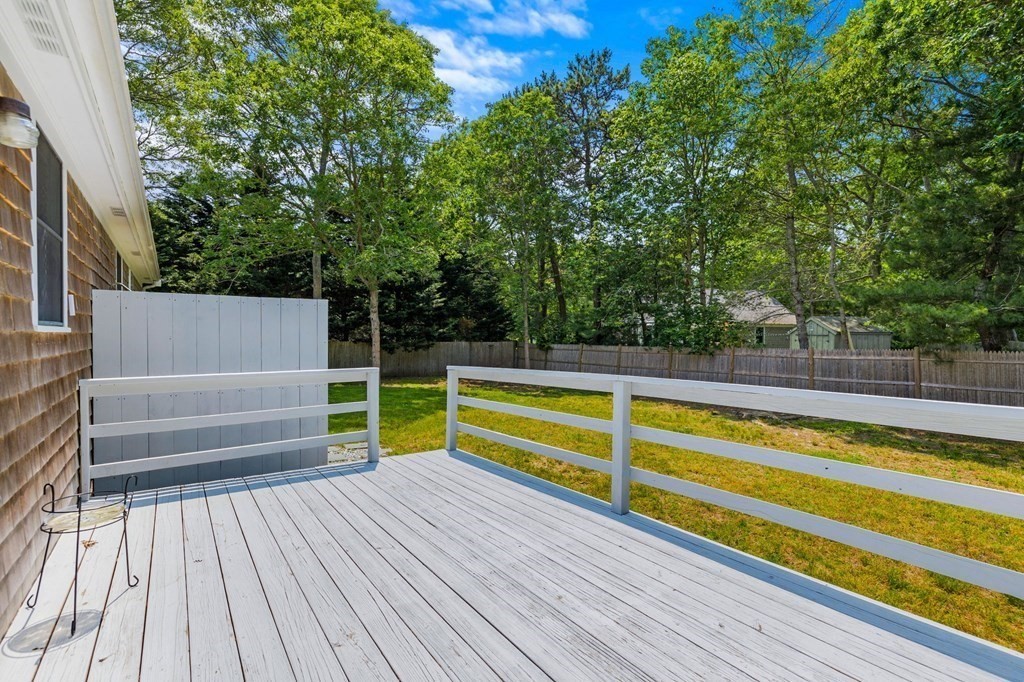 225 Skunknet Road Barnstable, MA 02632 - Photo 23 of 27 a view of a roof deck with wooden floor and fence