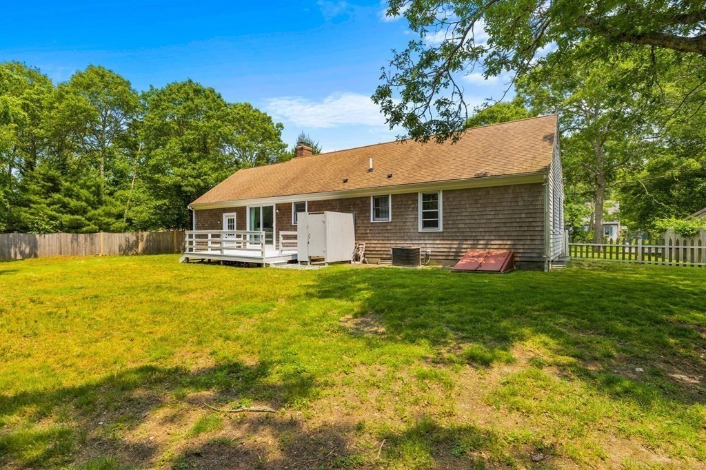 225 Skunknet Road Barnstable, MA 02632 - Photo 24 of 27 a front view of house with yard and outdoor seating