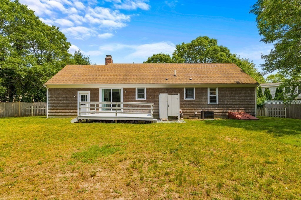 225 Skunknet Road Barnstable, MA 02632 - Photo 25 of 27 a front view of a house with swimming pool having outdoor seating