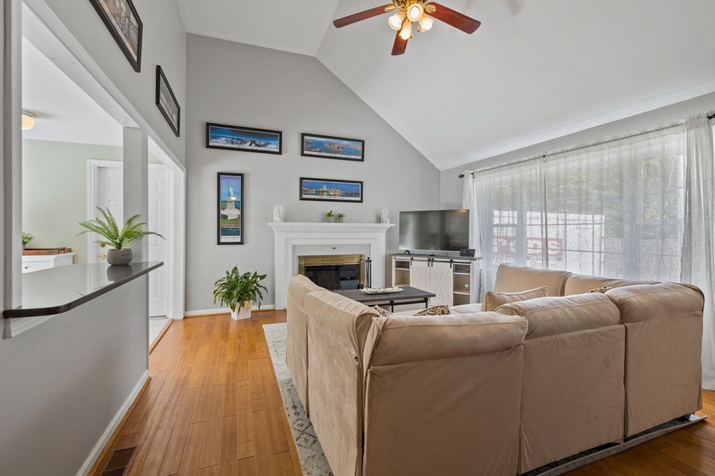 225 Skunknet Road Barnstable, MA 02632 - Photo 3 of 27 a living room with furniture a flat screen tv and a fireplace