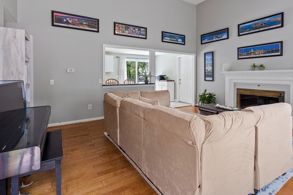 225 Skunknet Road Barnstable, MA 02632 - Photo 4 of 27 a living room with furniture and a fireplace